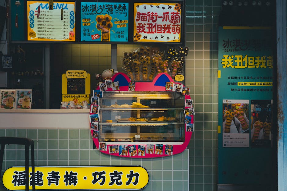 Vibrant café counter showcasing iced treats and pastries with colorful signage and decorative display.